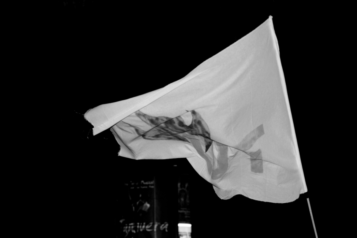 the front of a white flag, with a man's face drawn on it
