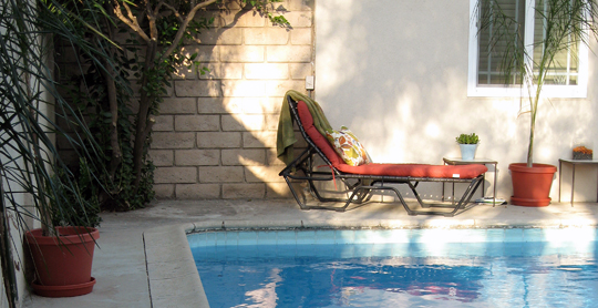 a pool is shown with chairs next to it