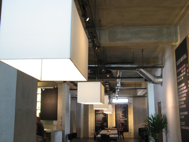 a large open room with two lights hanging from it's ceiling