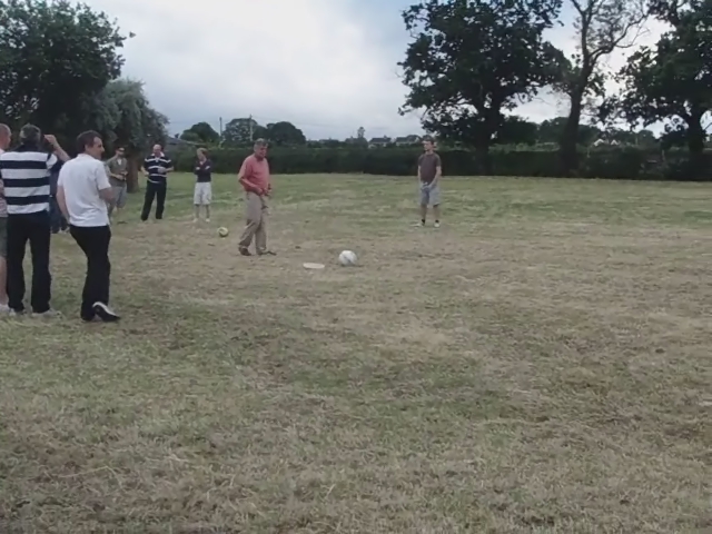 group of people gathered on the field with a soccer ball