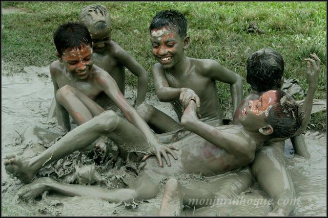 a group of s are playing in mud with each other