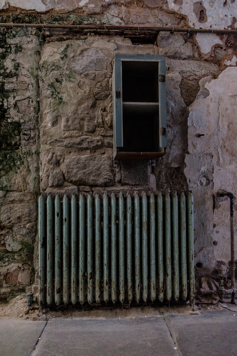 a radiator next to a wall in the shade