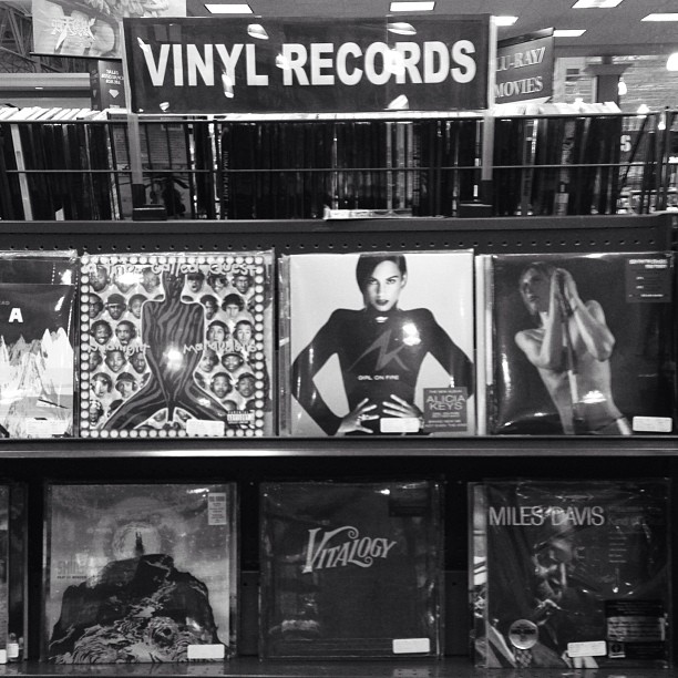 vinyl records displayed in a store with vintage poster posters