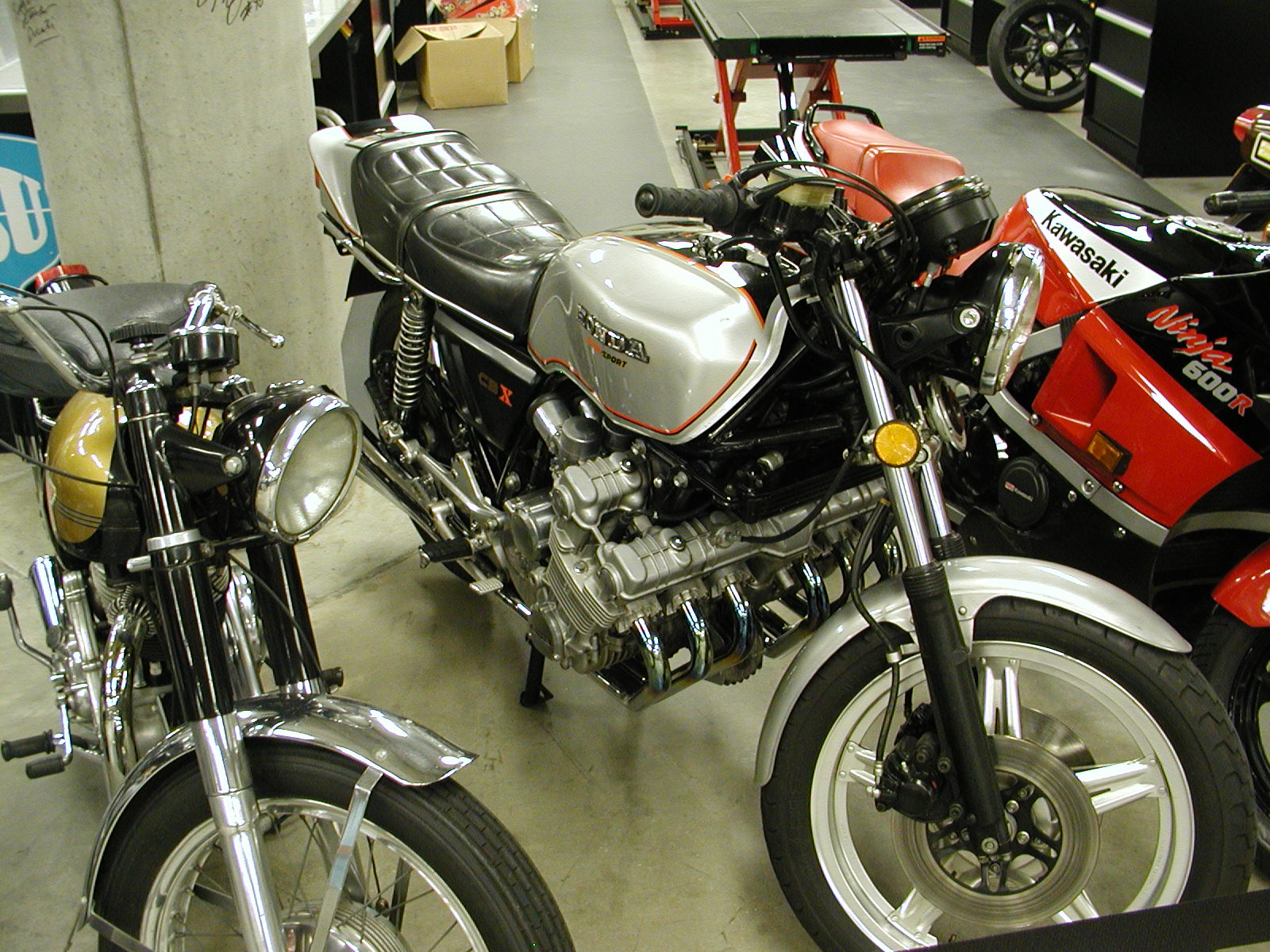 two motorcycle parked next to each other in a garage