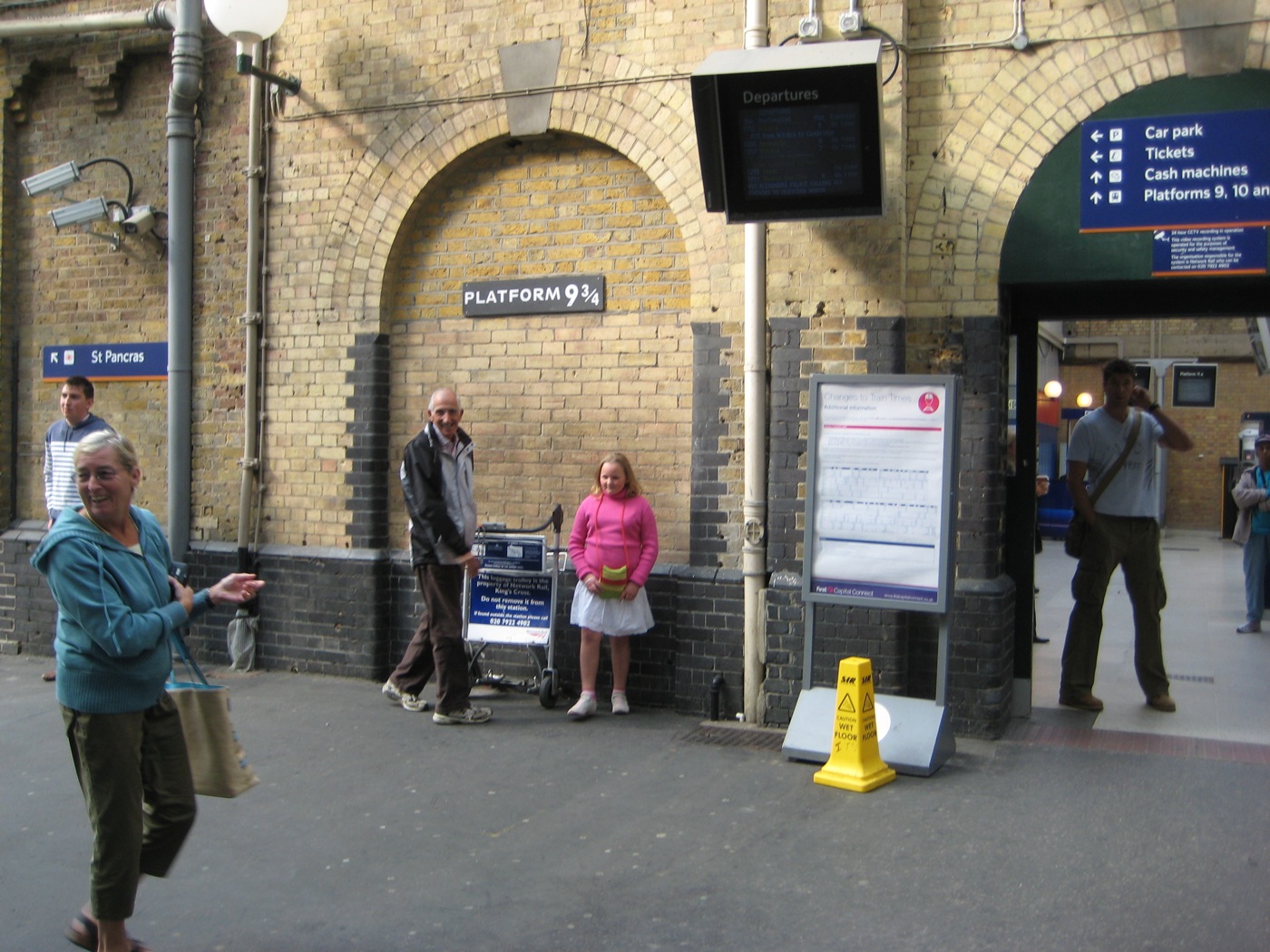 a couple of people standing at a train station