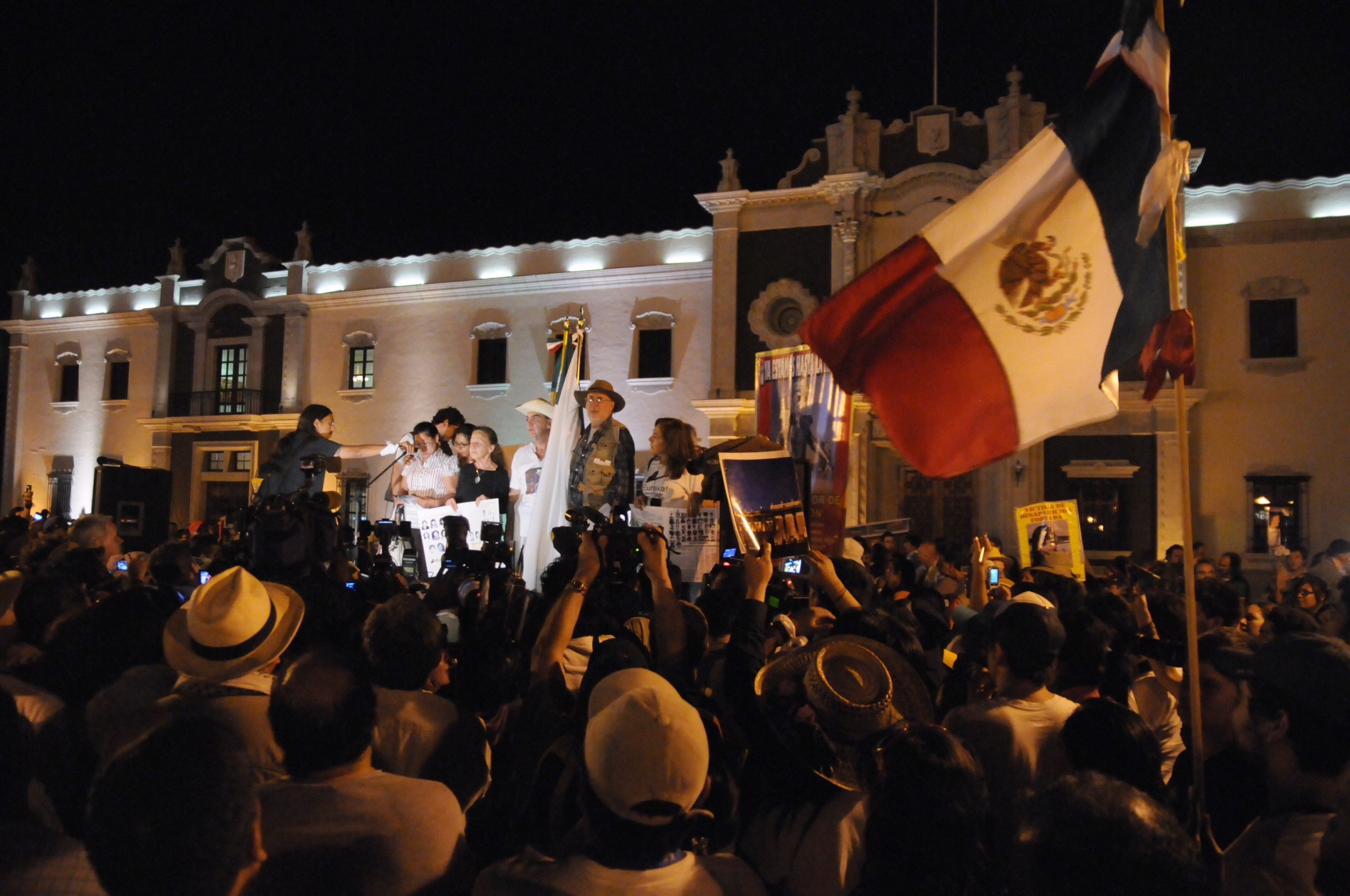 group of people at the national assembly waving flags