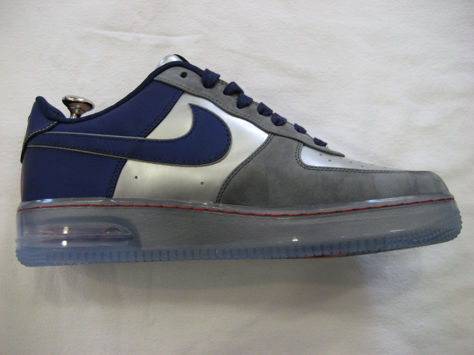 a gray and blue shoe with a light on the bottom