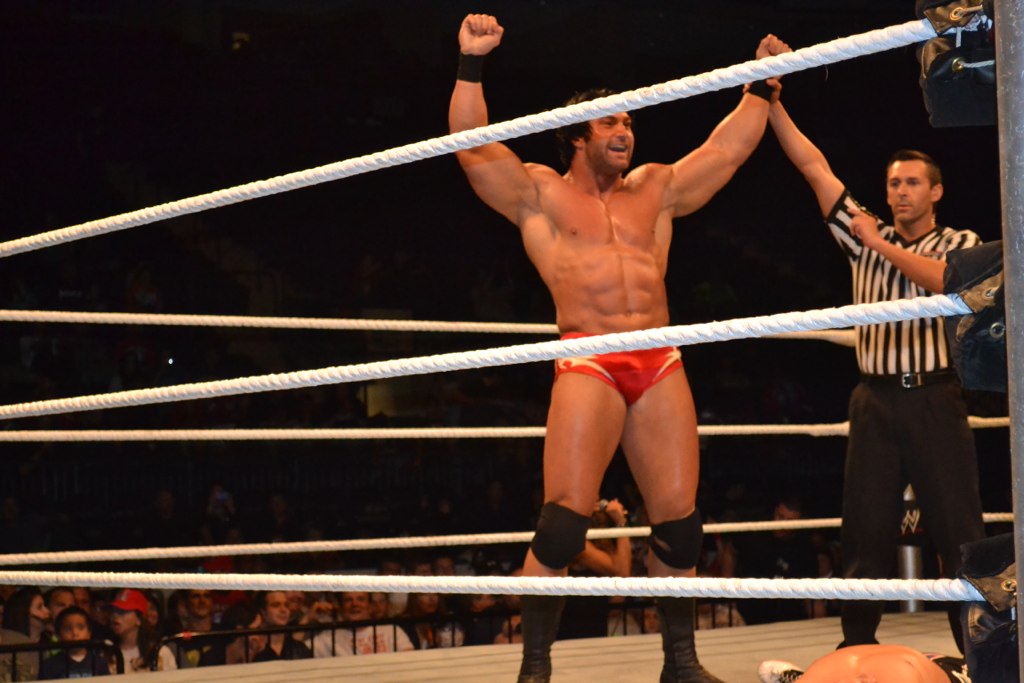wrestlers standing around and holding a rope