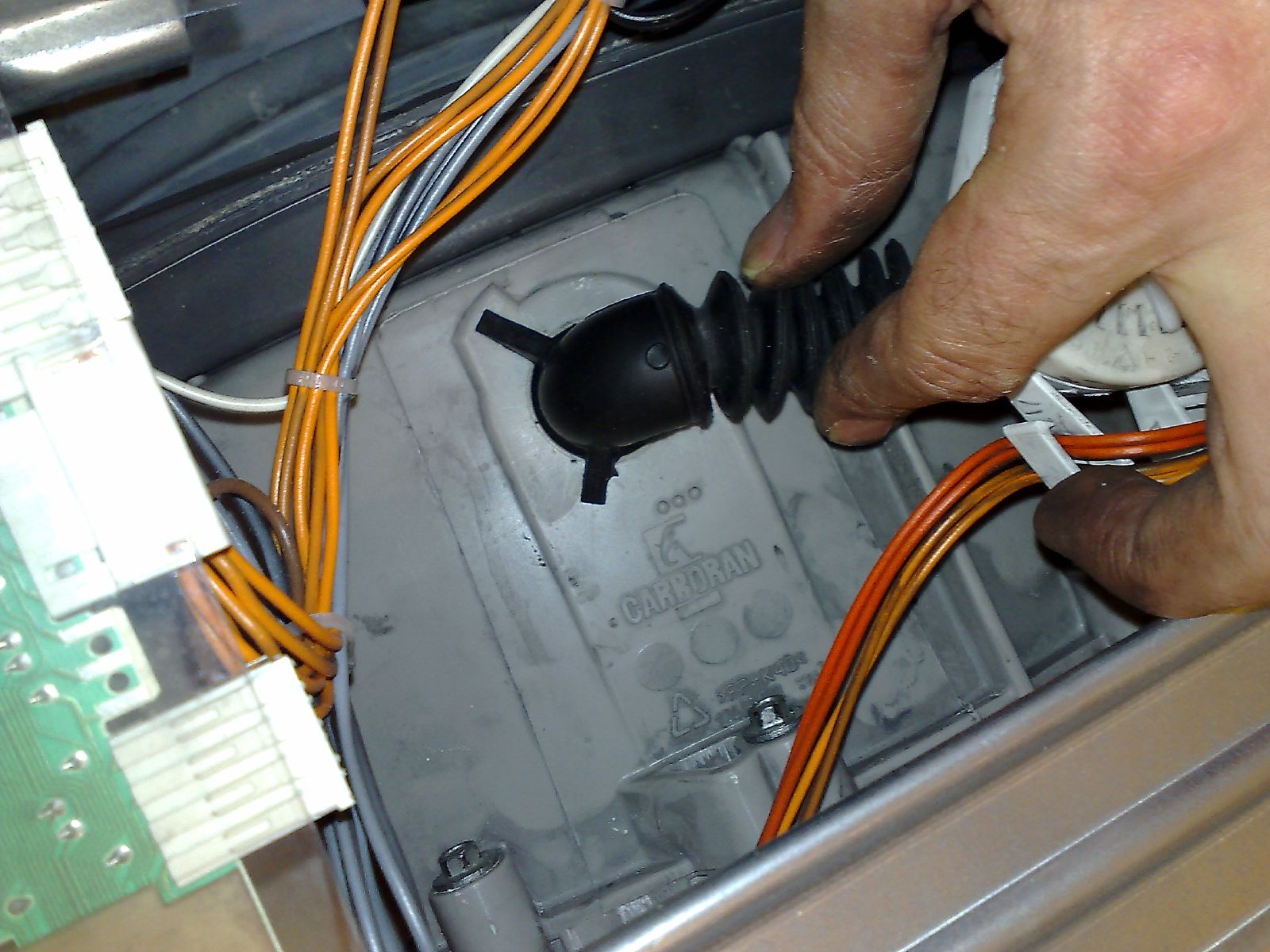 a person plugging the electrical wires into an electric outlet