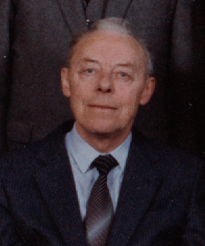 a older man dressed up and looking into the camera