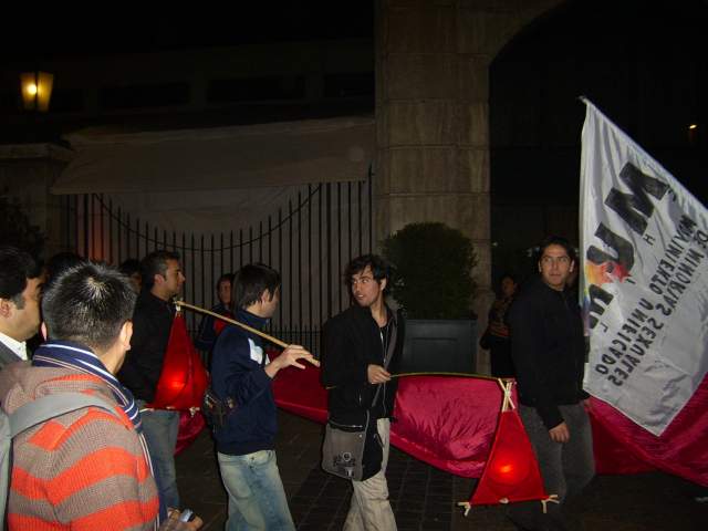 a group of people in the street with some banners