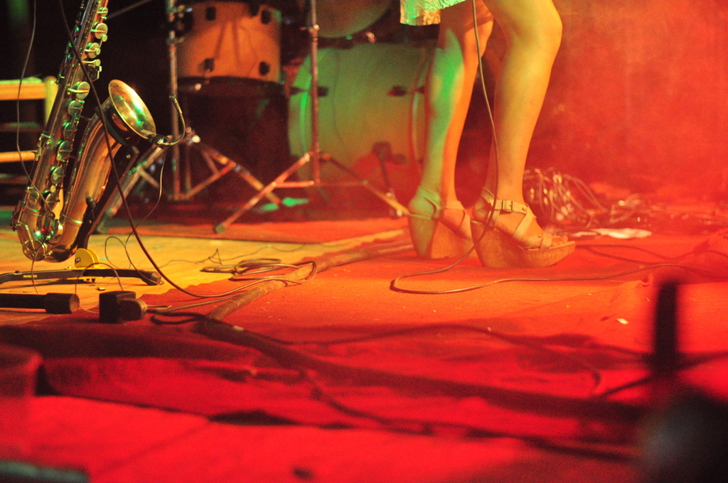 person's feet with shoes on in front of band