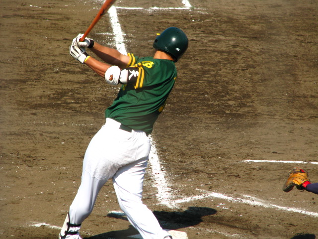 a baseball player is swinging his bat at a pitch