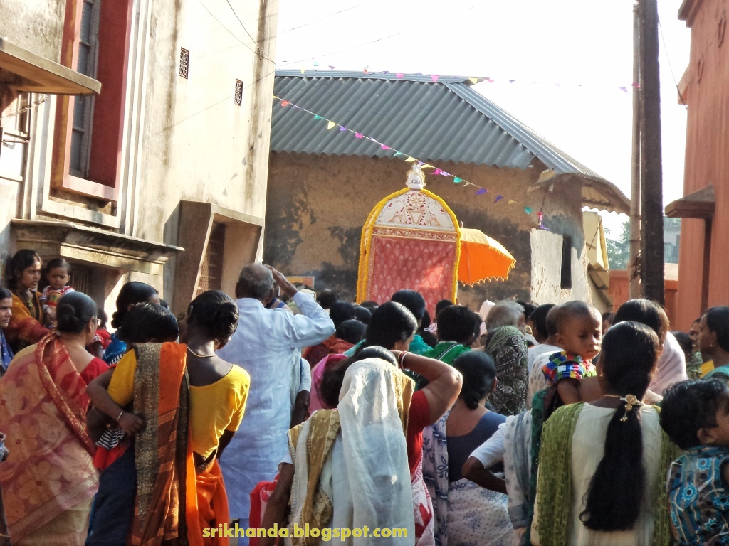 a group of people standing in line outside of a temple