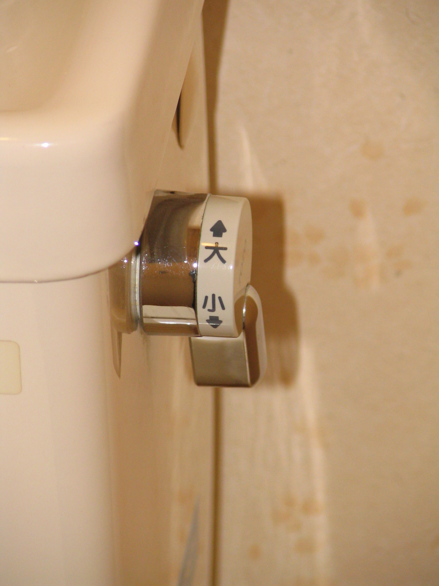 a sign that says toilet paper hanging on the side of a toilet