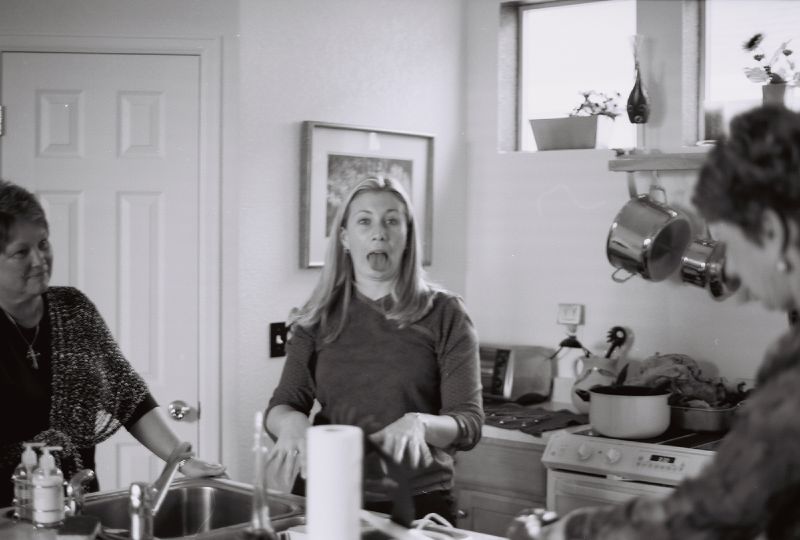 a black and white po of people in a kitchen