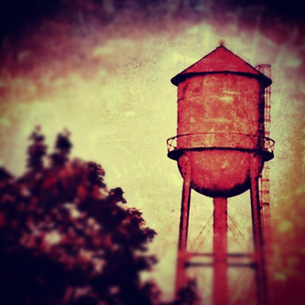 this is a painting of a large red water tower