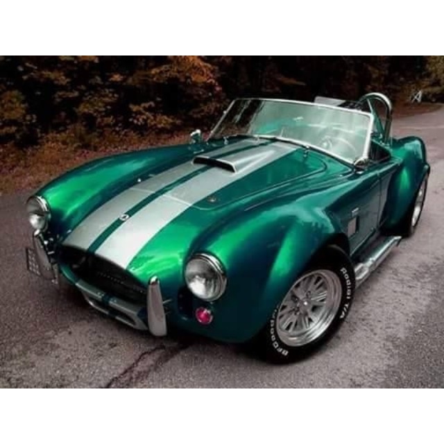 an old sports car in metallic, has been painted in green and white