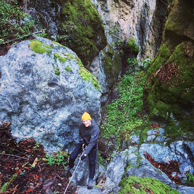 a man climbing up the side of a rock face