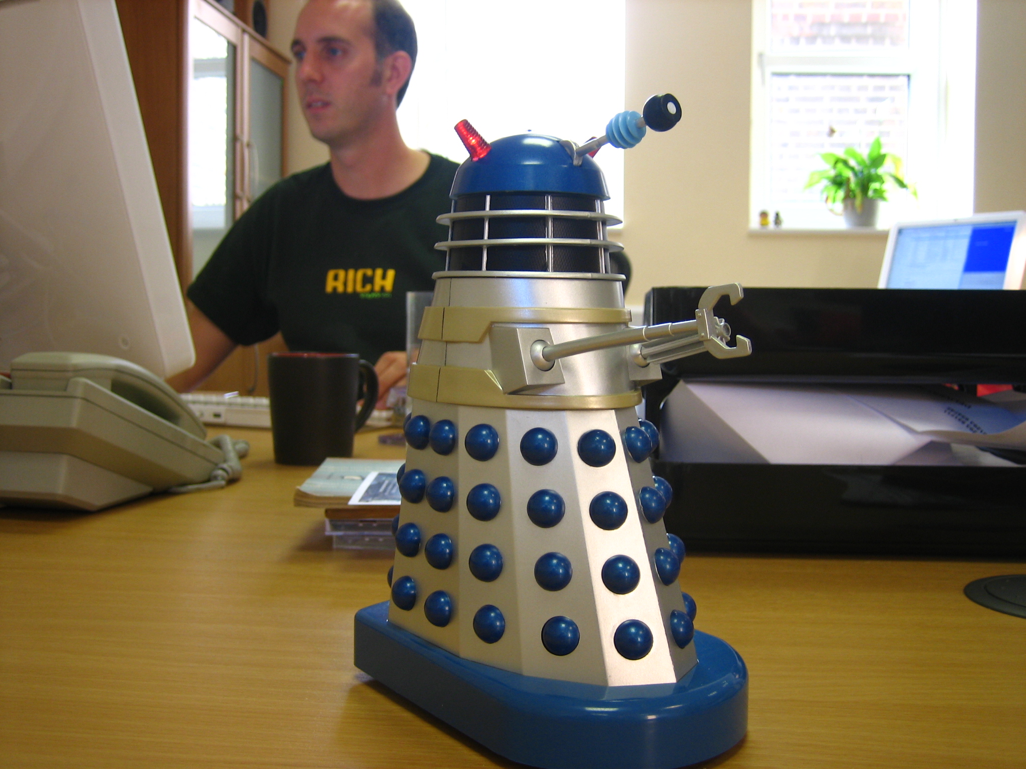 a figurine of the dalen doctor who stands near a computer