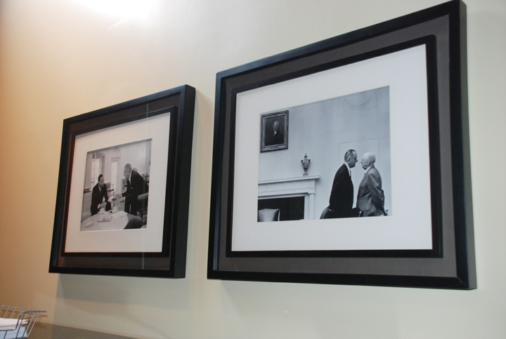 two black and white pographs hanging in a white room
