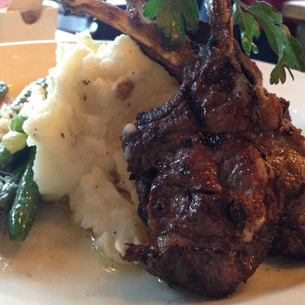 a close up of a plate of food with meat and mashed potatoes