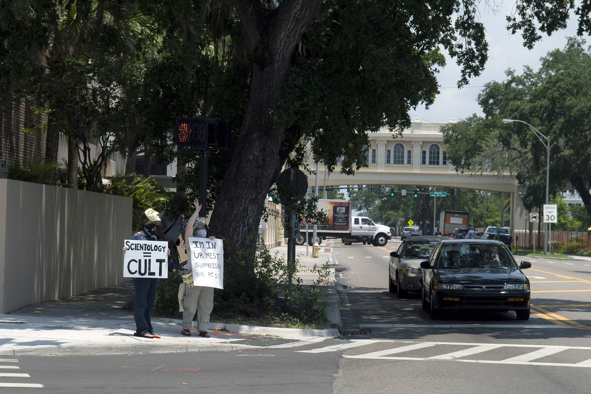 two men holding signs standing next to each other