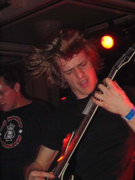 a man in black shirt playing an electric guitar