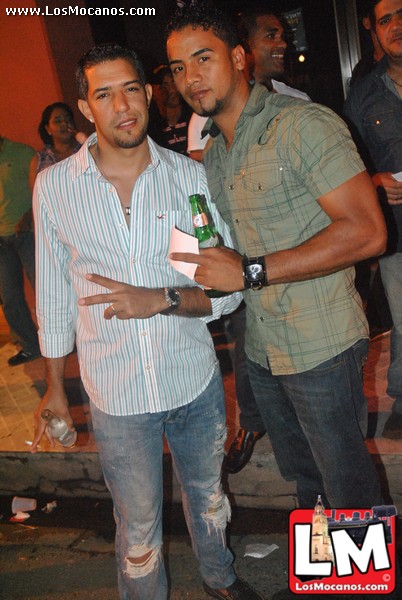 two men in shirt holding onto beer bottles