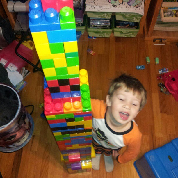 a  stands next to a pile of blocks