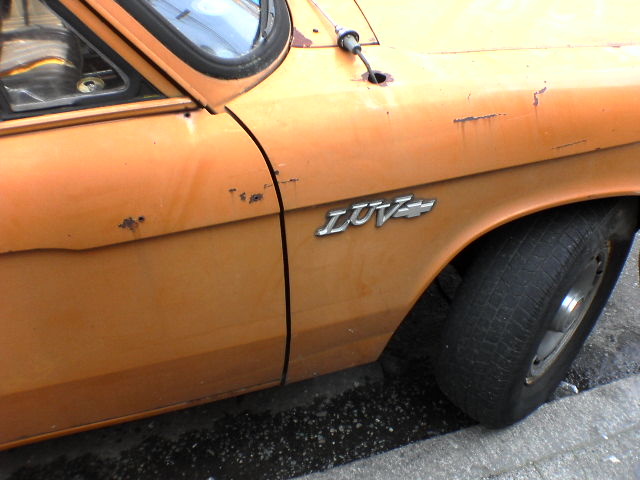an orange car with the words lotus written on it
