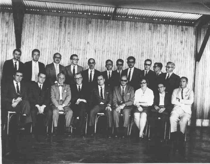 a group of men standing and sitting next to each other