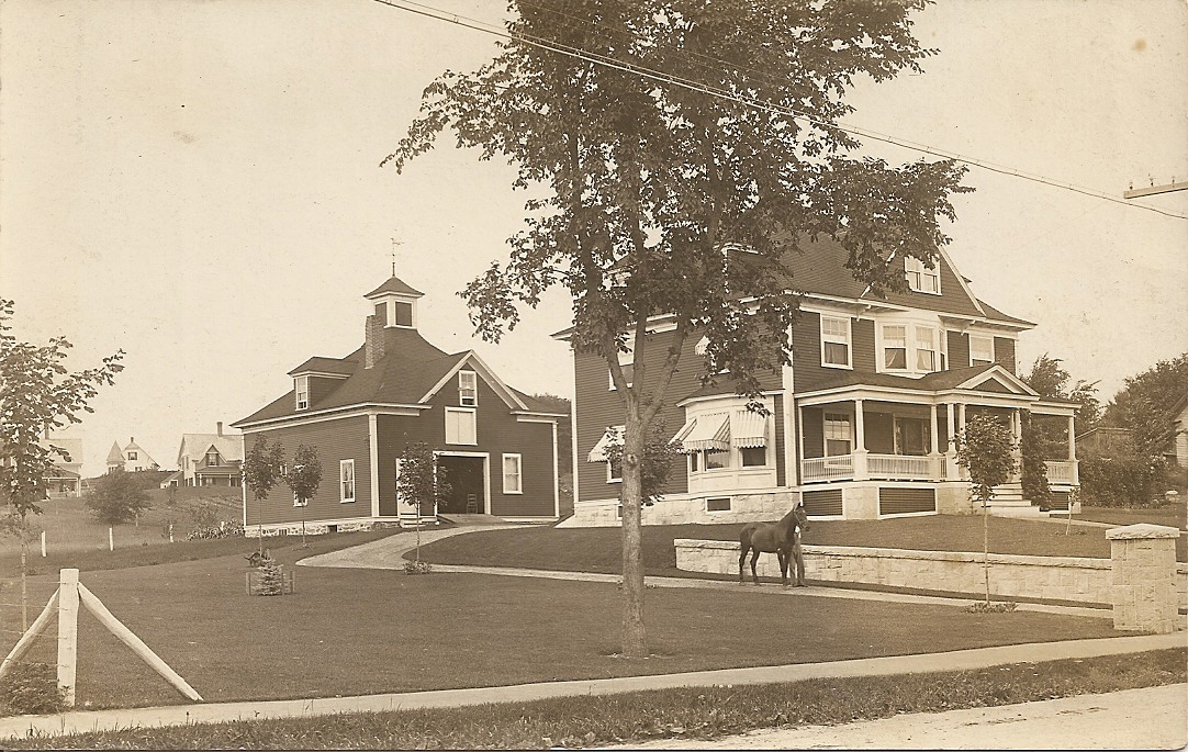 an old picture of a house with horse in the front yard
