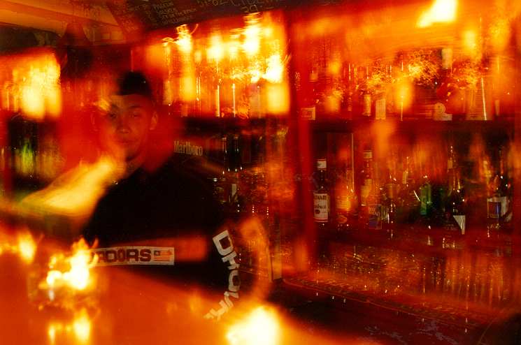 blurry pograph of a bar bartender in motion