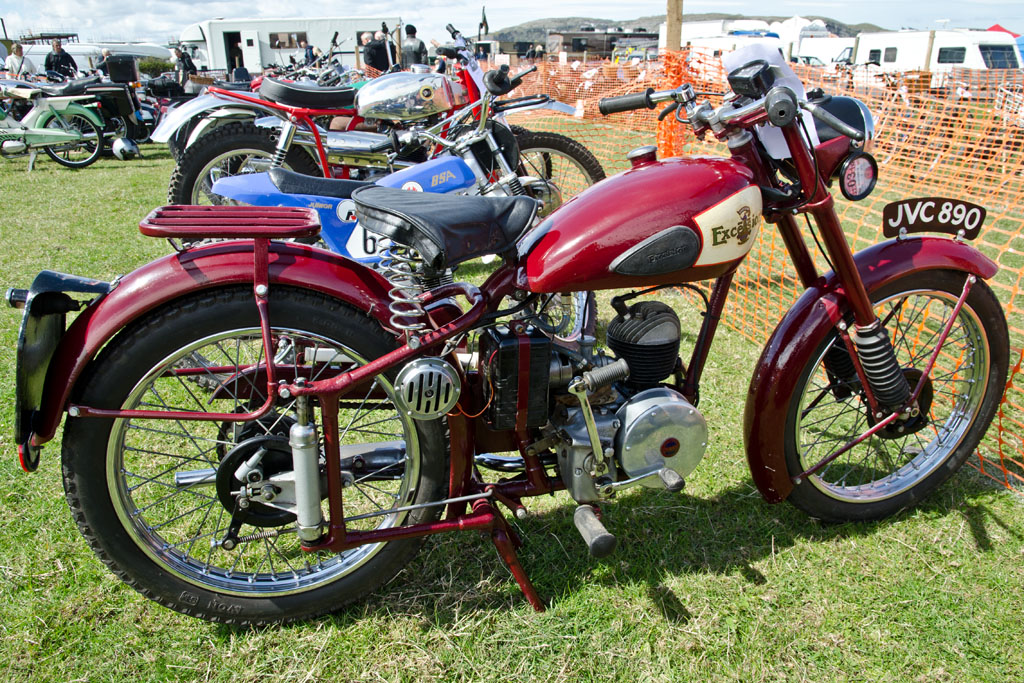 the motorcycle is parked in the grass near other bikes