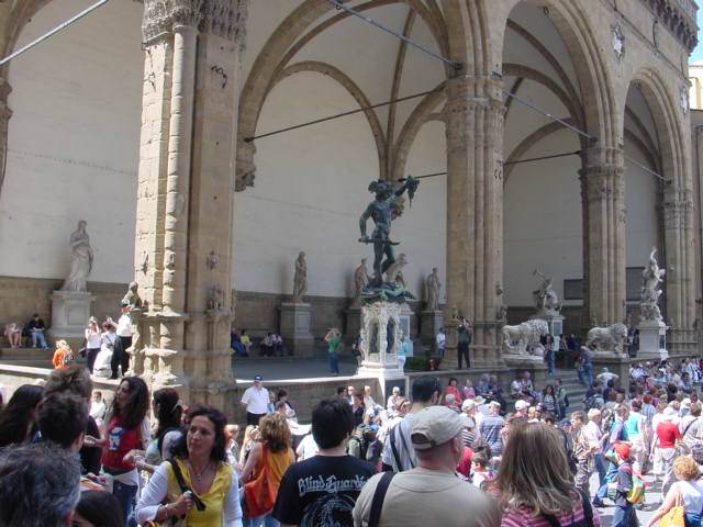 people gathering in a church courtyard for a performance