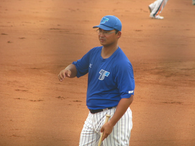 baseball player standing in the dirt holding his bat