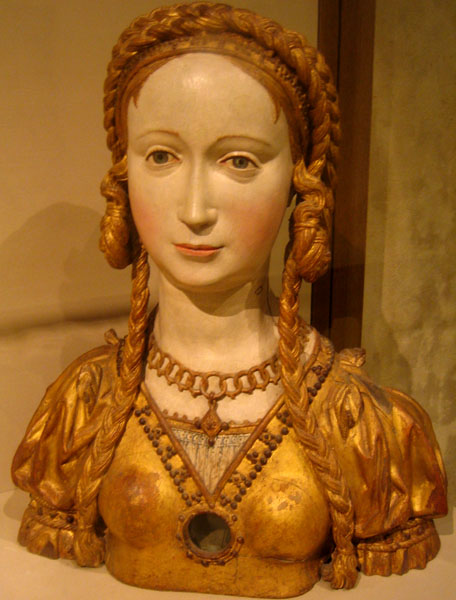 a gold busturine of a woman with id hair