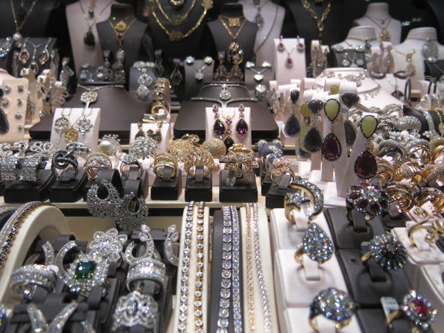 various jewels and celets are displayed in rows