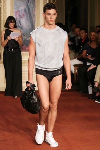 the man is wearing underwear with a bag on the runway