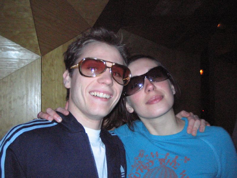 a young couple with sunglasses posing for a po
