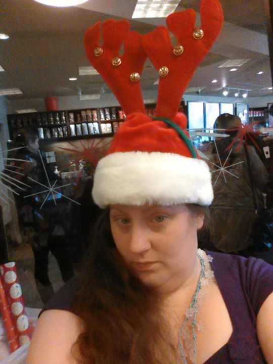 a woman in a santa hat with large horns
