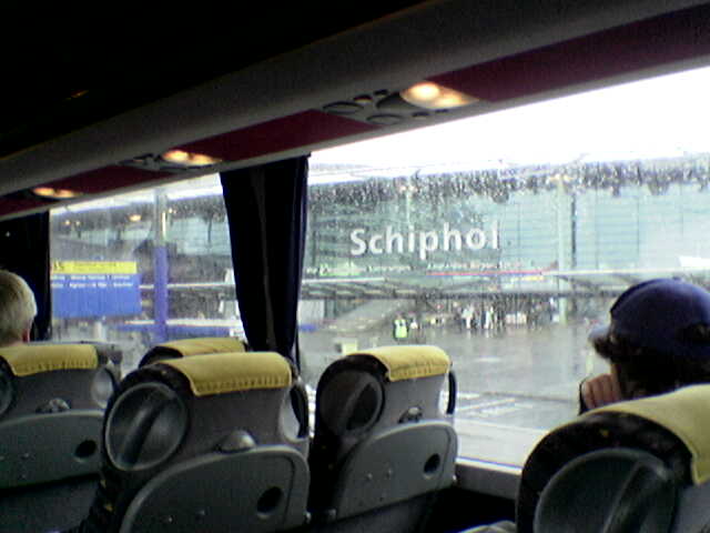 there is a view of a rain covered stadium from inside the bus