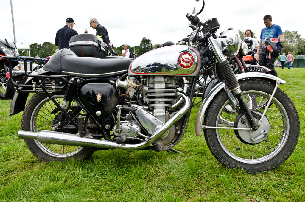 a motorcycle parked in a green field