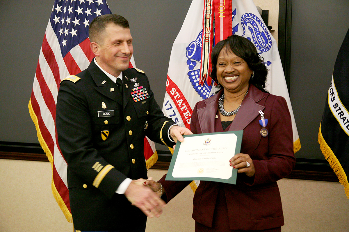 an older man receiving a certificate from a woman