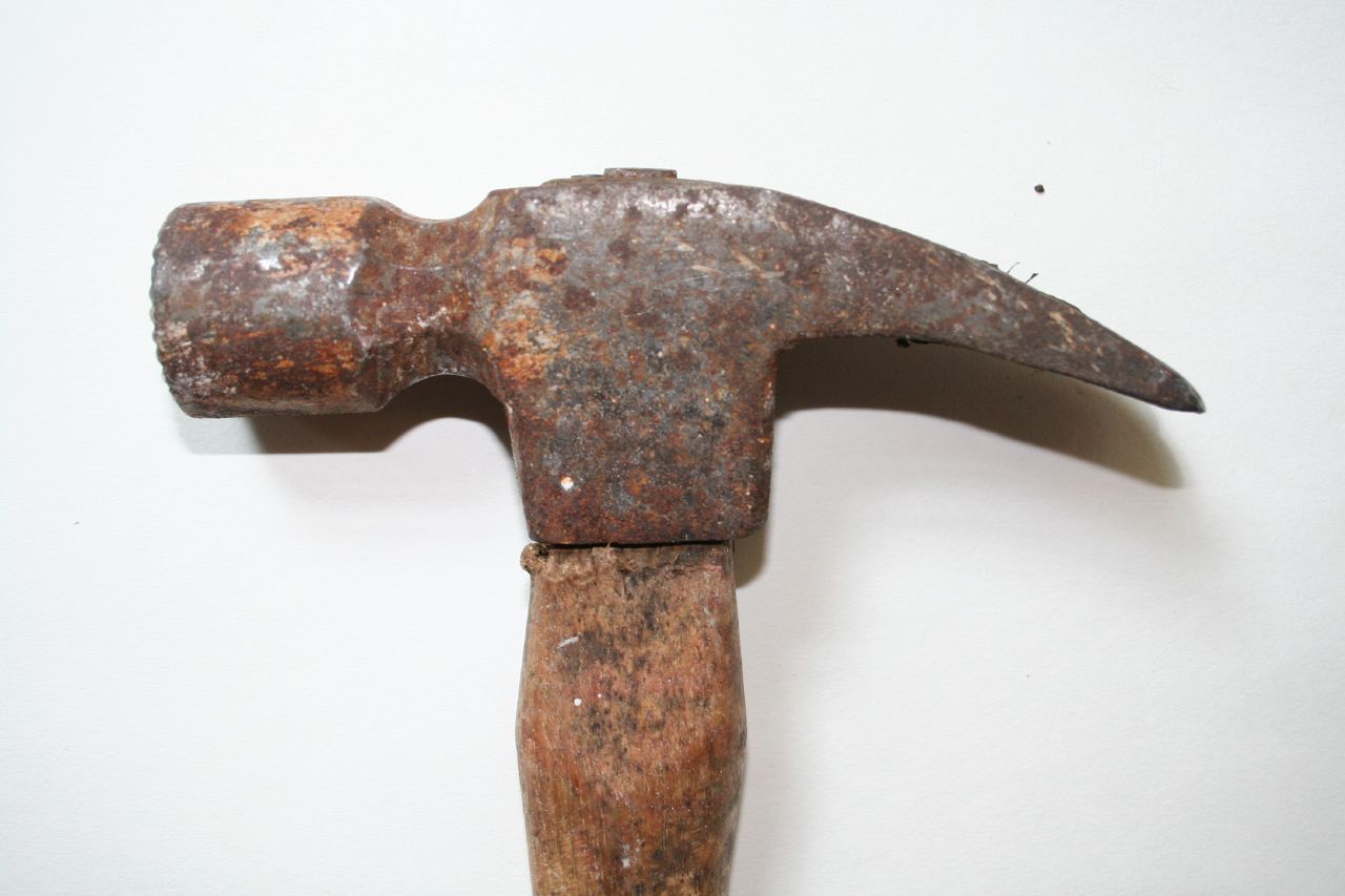 an old hammer that is old and rusty