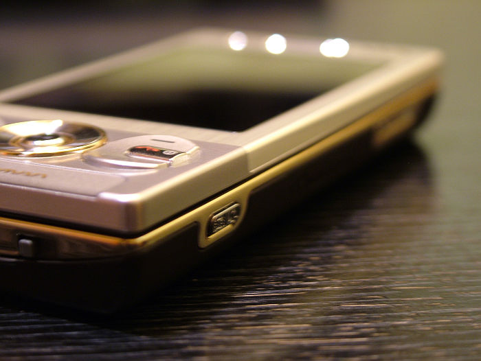the close up view of a cell phone with a gold frame