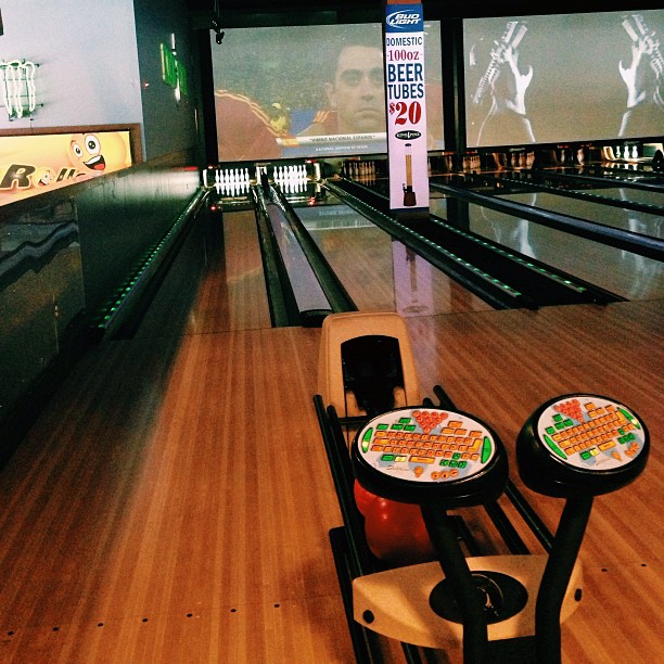 bowling pins with different colored plates on them and the bowling lanes showing