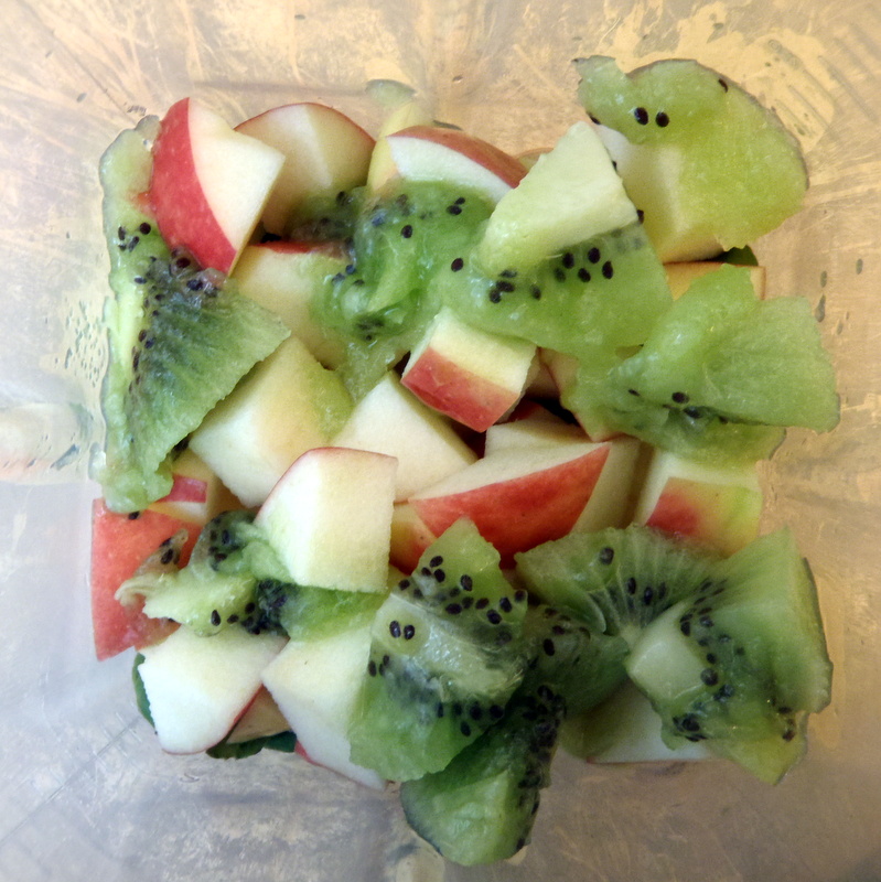 the vegetables have kiwi, melon, and apple slices on them