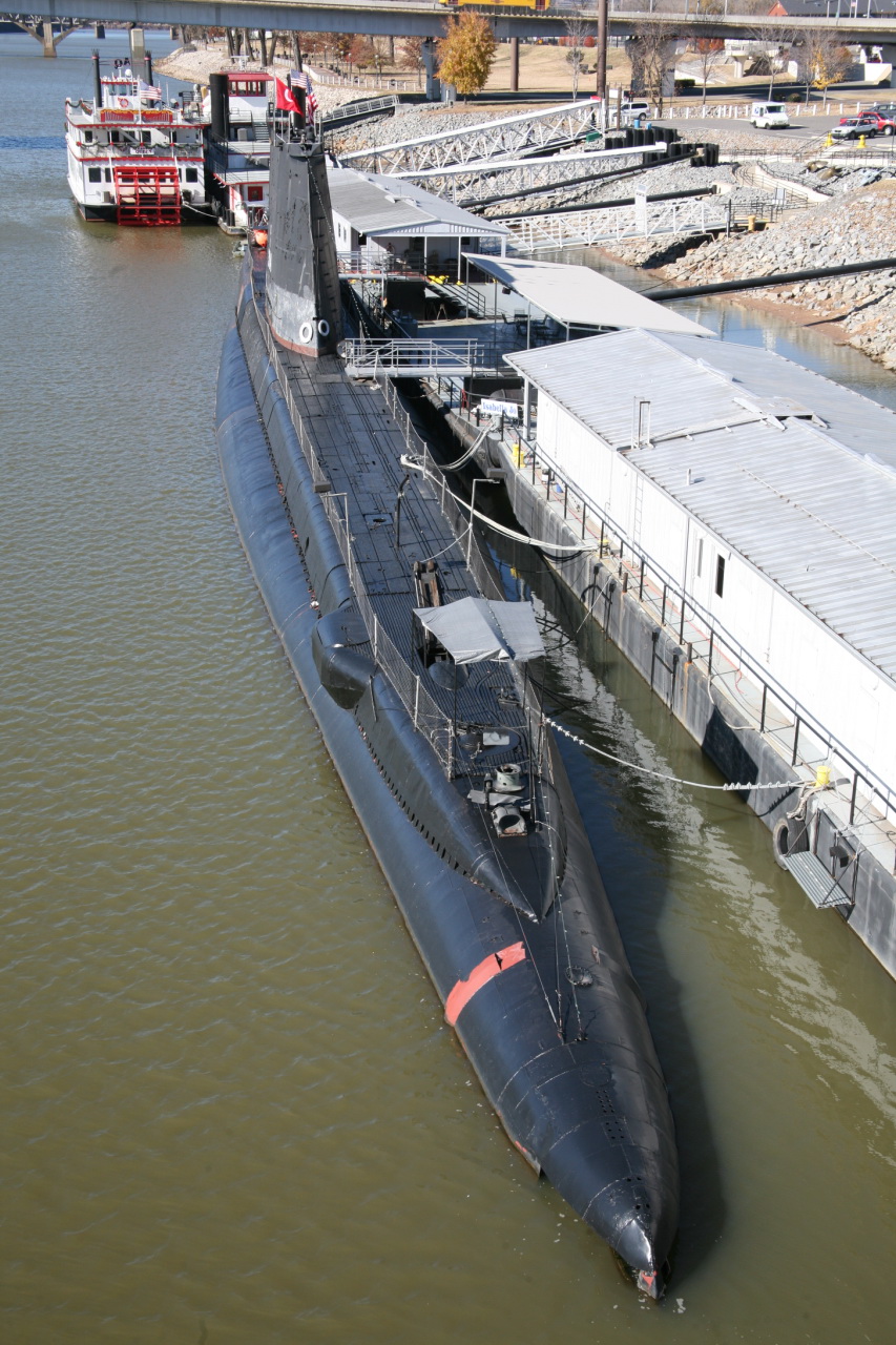 a submarine in the water next to a barge